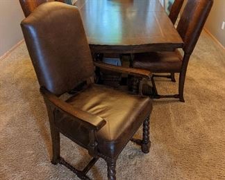 Eddie Bauer Lane Lakeridge Trestle Dining Set. A gorgeous set with leather and spindle leg chairs! There are a few light scratches on the table top, but all pieces are in otherwise great condition. The table includes two additional leaves.

The table measures 44” x 84” and 30” high and comes with two leaves each measuring 18" which allows toe table to extend to 102" or 120" for ample seating!

Each side chair measures 21” wide, 20” deep, 19” high to the seat and 43” high to the chair back.