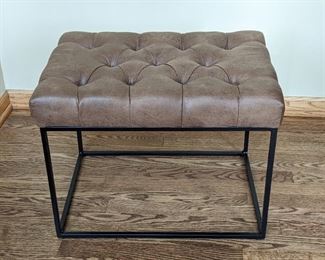 Tufted Faux Leather Footstool. Measures 16” x 22” and 16” high.