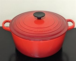 Le Creuset Enamel Dutch Oven. There is some light wear on the inner enamel that can be seen in the photos. Measures 4.5” high and 11” in diameter.