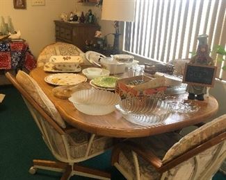 Dining table or breakfast table with 4 rolling chairs. Tons of platters, milk glass and glass bowls