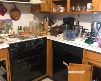 Utensils, Christmas glassware, pans, coffee and tea kettles. Rugs, crockpot, canisters and more serving dishes. 