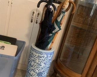 umbrella stand, plus umbrellas and walking sticks