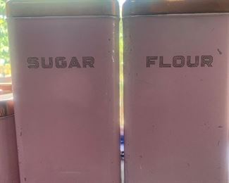 vintage pink canister set with gold lids and lettering: sugar, flour, tea, coffee