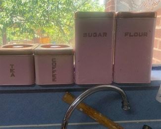vintage pink canister set with gold lids and lettering: sugar, flour, tea, coffee