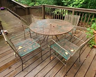 Vintage metal patio table and four matching chairs.  Imagine some spray paint!