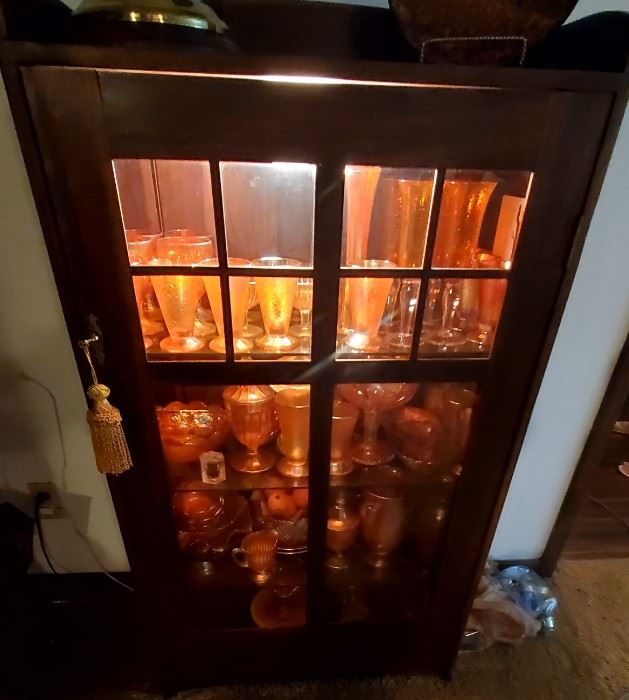 Black walnut Lighted China cabinet.  It is no longer legal.at this time to harvest and build with Black walnut trees and their wood.  This piece is special and increasingly rare. Lots of vintage carnival glass.