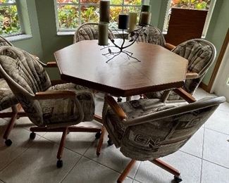 Kitchen table with one leaf and six rolling chairs