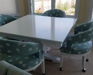 Tres chic dining table with upholstered dining chairs; set by Swain furniture