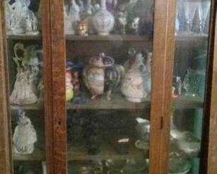 oak hutch filled with goodies   on top is a lovely mushroom slag lamp and a very unique antique spectacular fountain