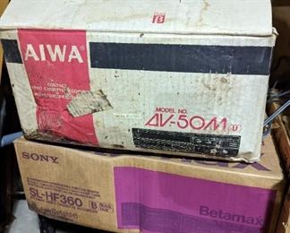 Two vintage betamax players with the box es
