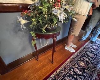 . . . a cute wall table with beautiful floral arrangement