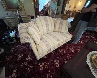 . . . one of two matching love seats in neutral colors