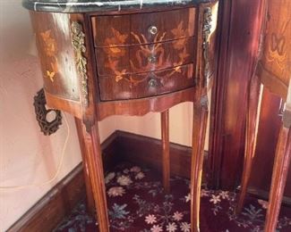. . . this is a petite marble-topped cabinet