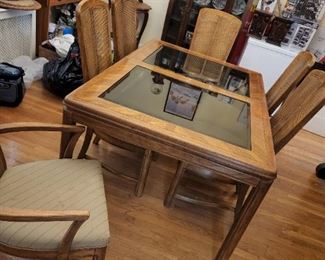 Wood and glass dining table with 6 rattan chairs and pads