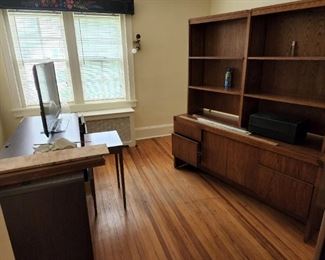 Mid century modern look credenza with bookcase top and wooden home office desk and flat screen TV