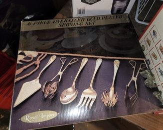 Never opened gold serving  utensils