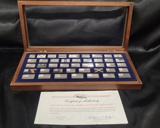 (50) Solid Sterling Silver Ingots: Official Flags
Franklin Mint The Official Flags of the United States Mini- Ingit Collection. 50 Solid Sterling Silver Mini- Ingots in wood & glass display case w COA & accompanying book