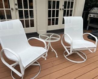 Pair, white swivel patio chairs with a round accent table