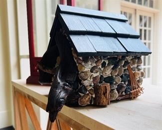 Artisan bird house with pebble accents and carved bird