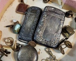 many different sterling silver vitorian cigarette lighters and coin purses.