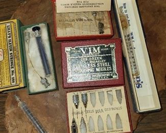 Antique early medical supplies imcluding the syringes pictured.