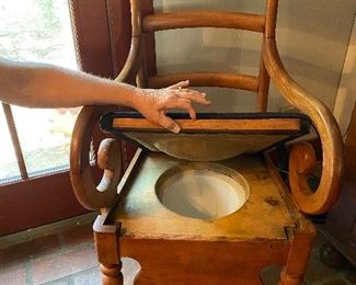 Antique wooden chair with chamber pot,