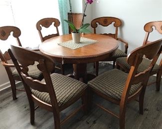 There are seven chairs with this table.  Shown round but with a leaf that will accommodate all chairs.  Two arm chairs.