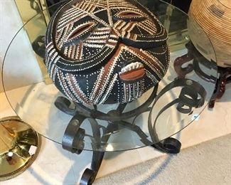 Tribal mask on glass top table