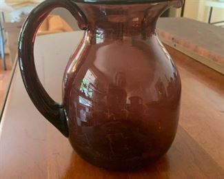 #20	purple blown glass pitcher 7 inches tall 	 $20.00 			
