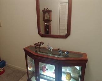 Lighted cabinet with matching mirror.
