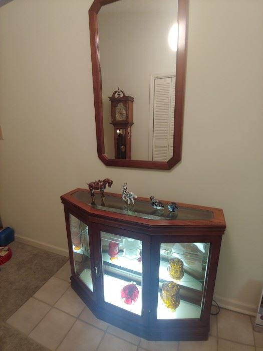 Lighted cabinet with matching mirror.