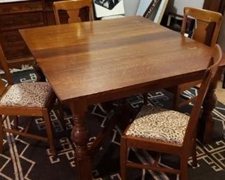 beautiful dining table with six chairs and four leaves