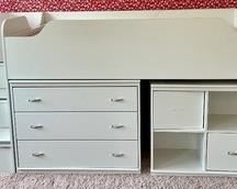 Lofted Children's Bed with Tuck Under Dresser and Cube Storage Unit. This is a dream bed for kids and it measures 94x47x49 inches. There is a crack on the side of the bed by the stairs. The tuck away cube storage until is missing handle and the door does not open without it. One of the doors on the stairs is missing the stopper so the door does not stop in the closed position.