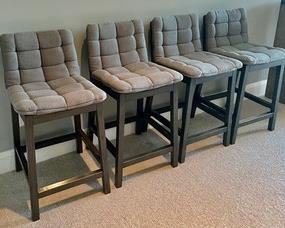 4 Wonderful Wooden Upholstered Bar Height Stools! These go great with the sofa table in lot 54! The stools measure 35 inches tall and 26 inches tall to the seat