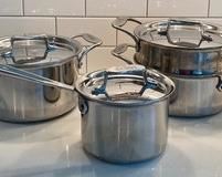 Three Pieces of All-Clad Cookware all in good/used condition. Includes; 4 quart covered pot, three quart covered pot with steamer basket and two quart covered saucepan