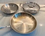 Three All-Clad Frying Pans with varying degrees of wear. Includes one 12" pan, three quart and one 10" pan.