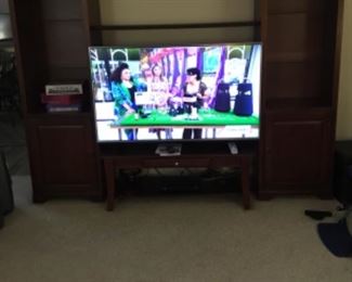 Large TV entertainment center - shelf above TV - large Tv (also for sale) - shelves on either side of TV and additional storage under TV. 