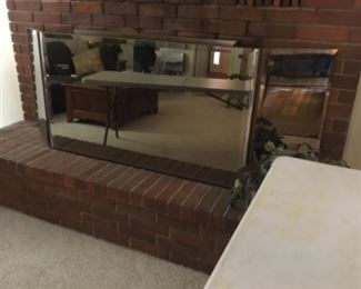 Large mirror covering the fireplace 