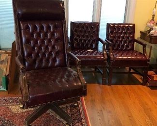 2 Leather and brass tack chairs and one desk chair on rollers