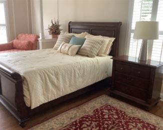 Queen Sleigh bed..by Hooker furniture.  Headboard measures 57” high and footboard is 31” high.