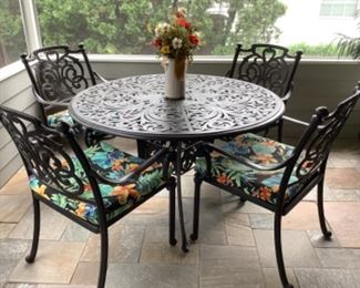 St. Augustine wrought iron patio set. 48” round table with four chairs…part of set.