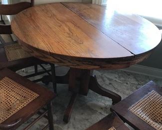 #40	Round oak Pedestal Table on Wheels - 42Round x 29"T - w/4 chairs (all chairs need cane seat replaced)	 $75.00 
