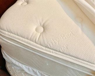 Sealy Mattress with bed. Has been covered in a protective mattress cover.