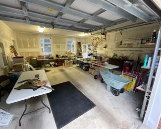 garage full of misc tools and pool gear, chairs, toolboxes and  the like 