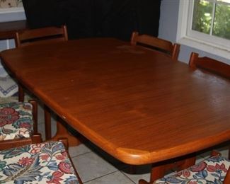 Item #7 - vintage MCM - Teak  Danish Modern Hidden Leaf Dining table 2-leaves w/8 chairs - 65" L, 39" W, 29" T  (each leaf adds 19 1/2" to length) made by Dyrlund - One leaf has damage to side - $2.250