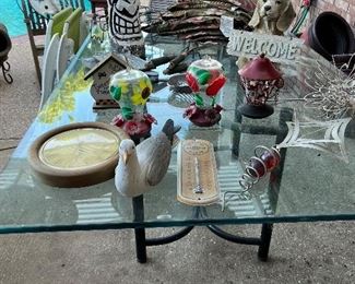 Large glass iron outdoor table; teak furniture