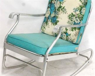 213 - 1950s Aluminum rocker with turquoise cushions 33 x 25 1/2 x 33
