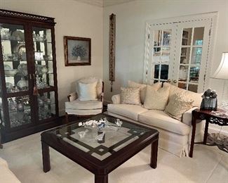 Matching love seats upholstered in cream velvet