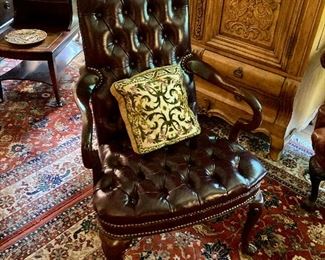 Pair of oxblood tufted leather armchairs by Hancock & Moore