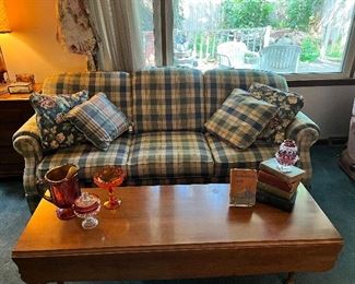 Blue check sofa, matching love seat, and coffee table. Antique books, carnival glass, And other decorative glassware